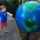 Boy spinning giant globe